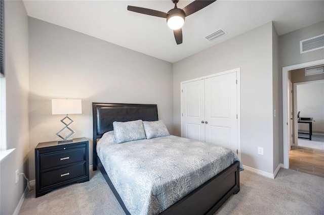 bedroom featuring light carpet, a closet, and ceiling fan