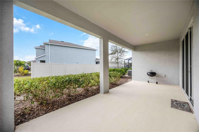 view of patio / terrace with a lanai and central AC