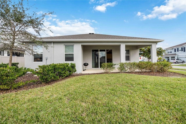 12689 Promenade Estates Blvd, Sarasota, FL 34238 - back of house featuring stucco siding and a yard