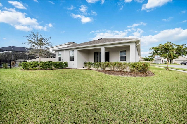 view of front facade featuring a front lawn and a lanai