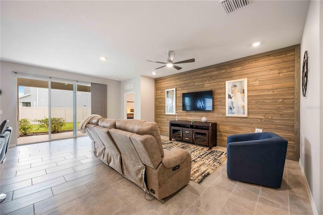 12689 Promenade Estates Blvd, Sarasota, FL 34238 - living room featuring an accent wall, ceiling fan, recessed lighting, and wood walls
