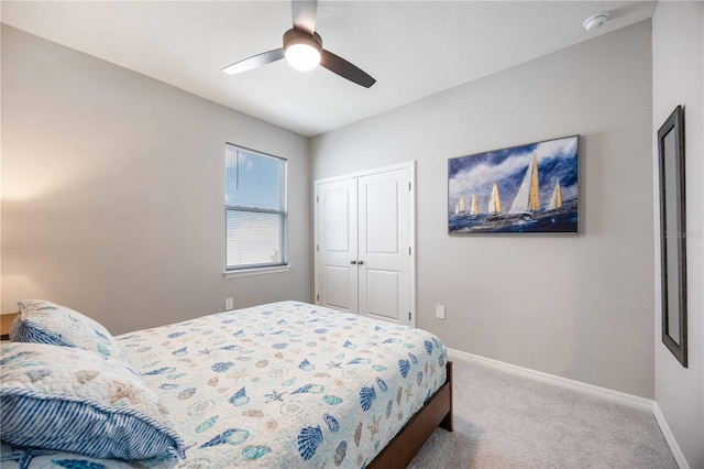 carpeted bedroom with a closet and ceiling fan