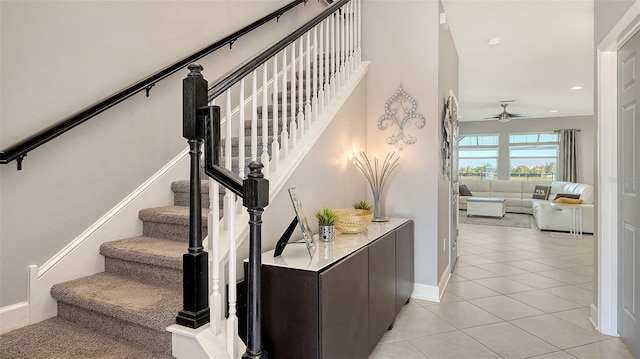 stairway with tile patterned flooring and ceiling fan