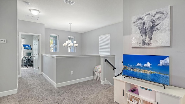 interior space featuring light carpet and an inviting chandelier