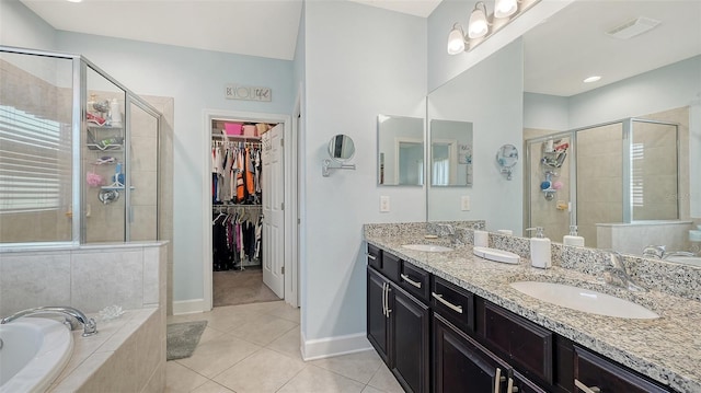 bathroom with tile patterned flooring, vanity, and separate shower and tub