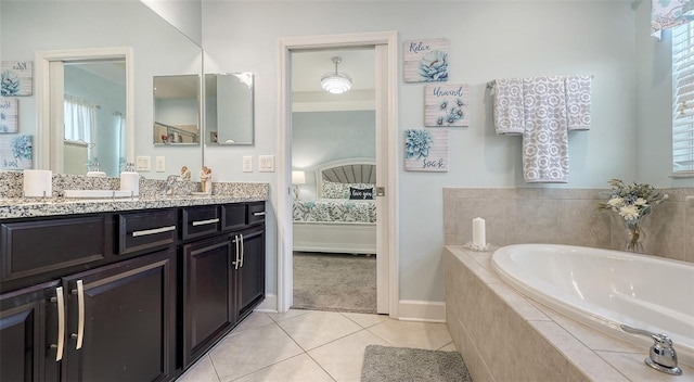 bathroom featuring tile patterned flooring, vanity, and a relaxing tiled tub