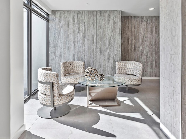 sitting room with tile patterned floors, recessed lighting, and baseboards