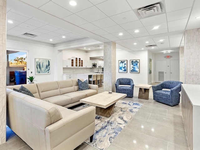 living room with recessed lighting, visible vents, and light tile patterned flooring