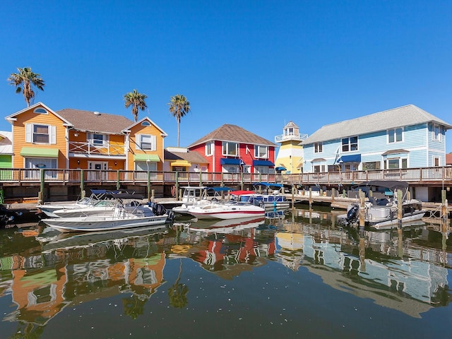 view of dock with a residential view and a water view