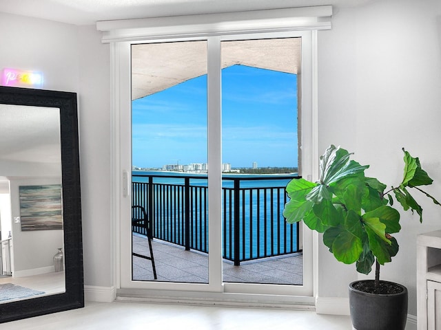 doorway featuring baseboards and a wealth of natural light