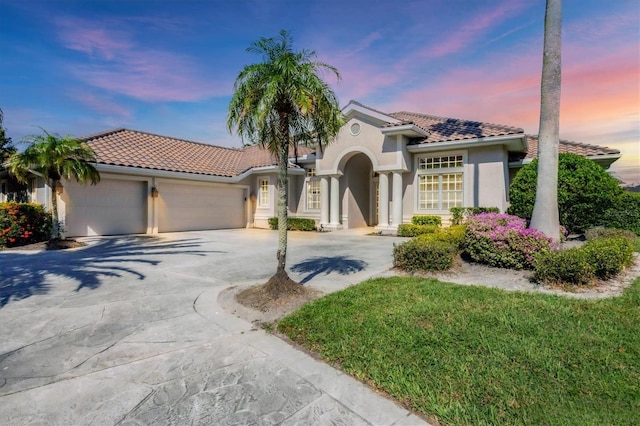 mediterranean / spanish-style house with a garage