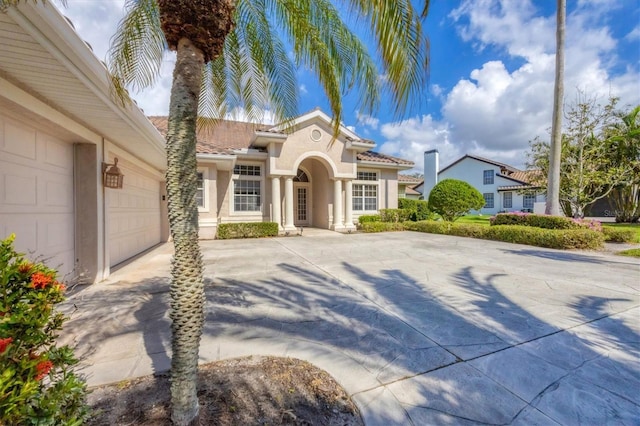 mediterranean / spanish house featuring a garage