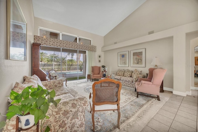 living room featuring light tile patterned flooring and high vaulted ceiling