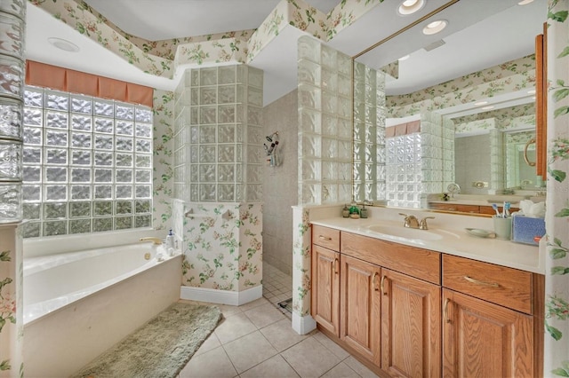 bathroom with tile patterned flooring, vanity, and separate shower and tub