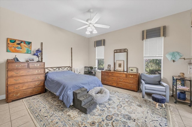 bedroom with multiple windows, ceiling fan, and light tile patterned floors