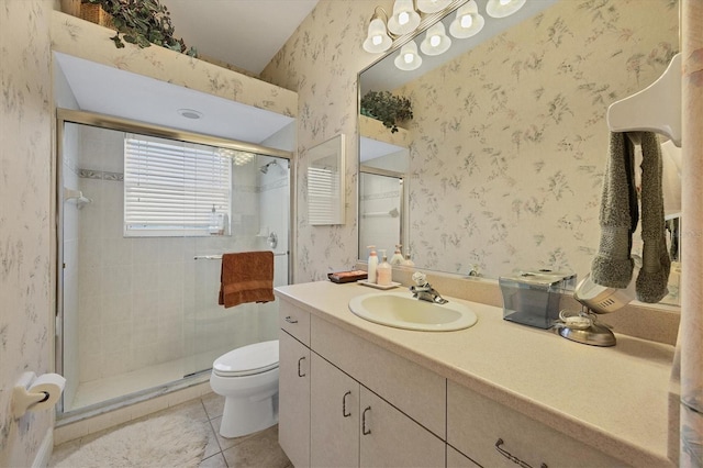 bathroom with tile patterned flooring, vanity, toilet, and a shower with door