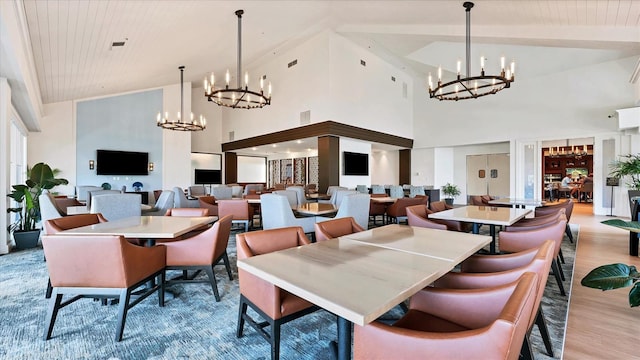 dining space with beam ceiling, wooden ceiling, high vaulted ceiling, a notable chandelier, and light hardwood / wood-style floors