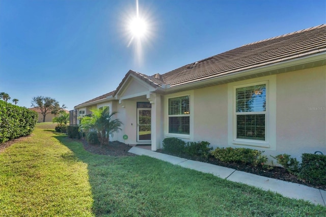 view of side of home featuring a lawn