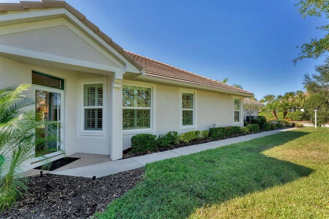 view of property exterior featuring a lawn