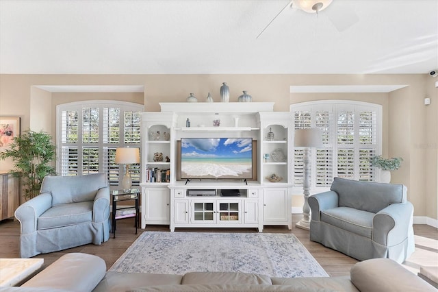 living room featuring hardwood / wood-style floors and ceiling fan