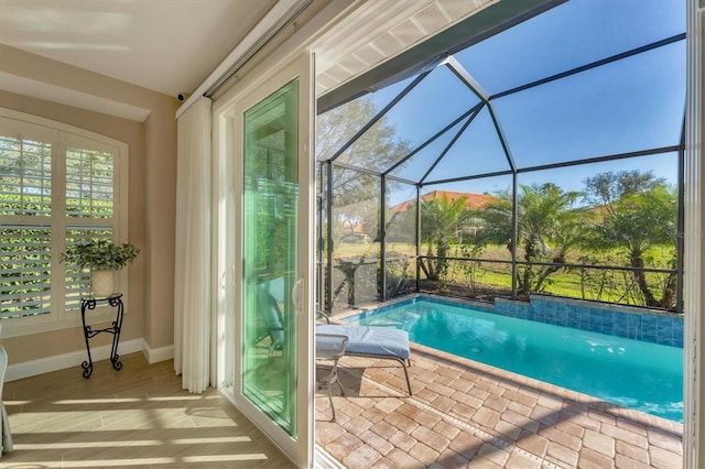 view of swimming pool with a lanai and a patio