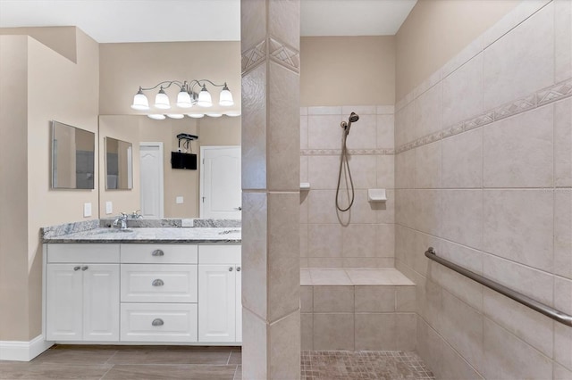 bathroom with a tile shower, hardwood / wood-style floors, and vanity