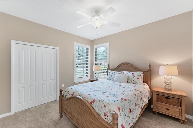 carpeted bedroom with a closet and ceiling fan