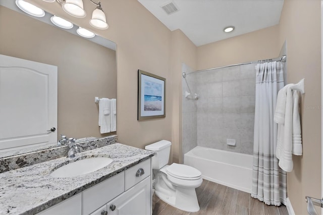 full bathroom featuring hardwood / wood-style floors, vanity, toilet, and shower / bath combo with shower curtain