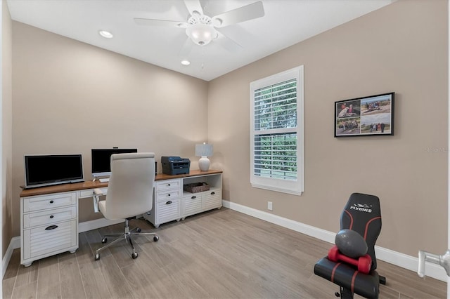 home office featuring ceiling fan and light hardwood / wood-style floors