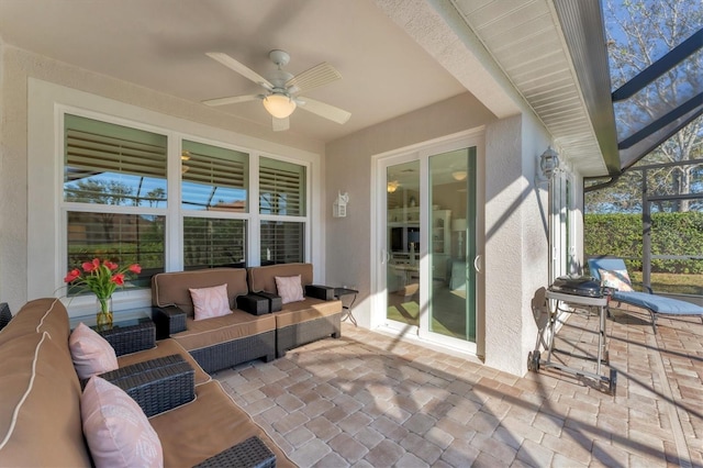 view of patio / terrace with ceiling fan, a lanai, and an outdoor hangout area