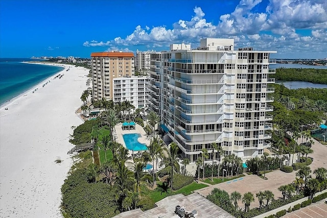 view of property featuring a water view and a beach view