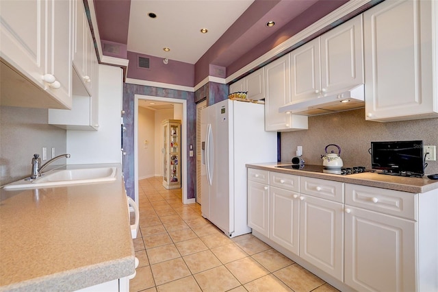 kitchen featuring white cabinetry, sink, white refrigerator with ice dispenser, black electric stovetop, and light tile patterned floors