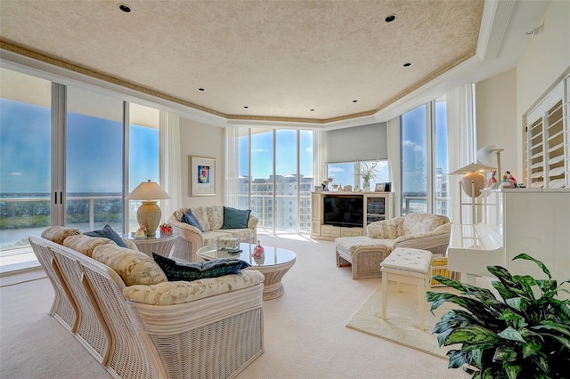 carpeted living room featuring expansive windows, crown molding, a textured ceiling, and a water view