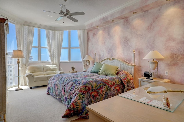 carpeted bedroom featuring ceiling fan and crown molding