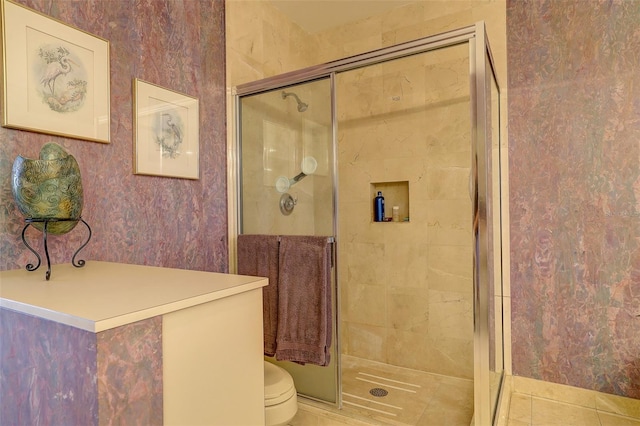 bathroom with tile patterned floors, walk in shower, and toilet