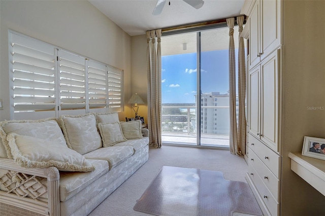 living room featuring ceiling fan and light colored carpet