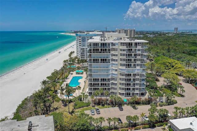 bird's eye view featuring a water view and a beach view