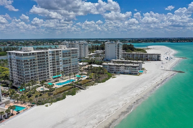 bird's eye view featuring a view of the beach and a water view