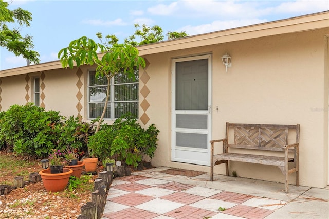 property entrance featuring a patio