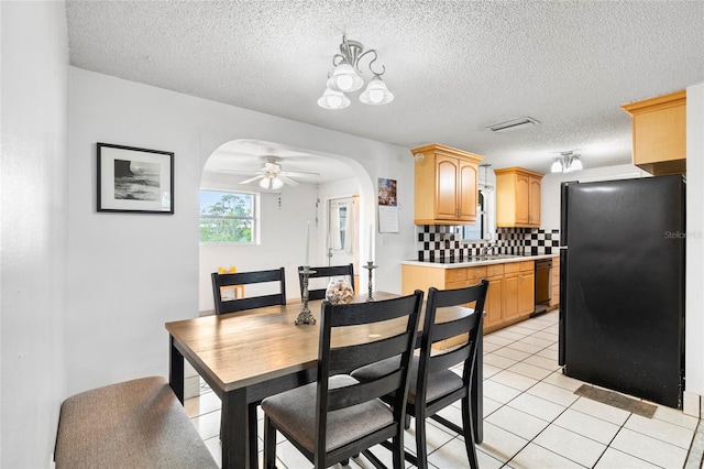 dining area with sink, a textured ceiling, ceiling fan, and light tile patterned flooring