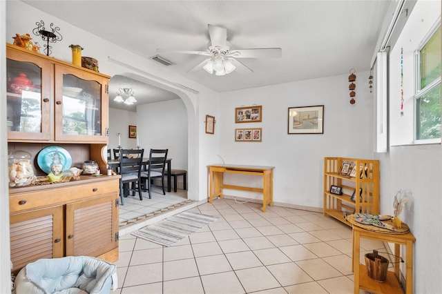 interior space with ceiling fan and light tile patterned floors