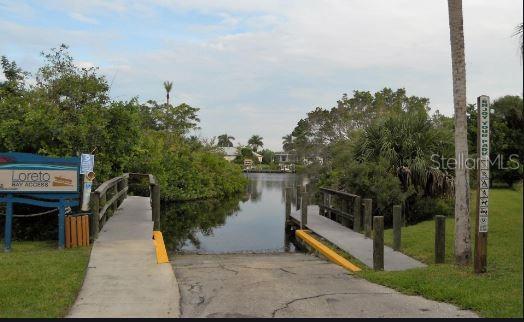 view of community featuring a boat dock and a water view