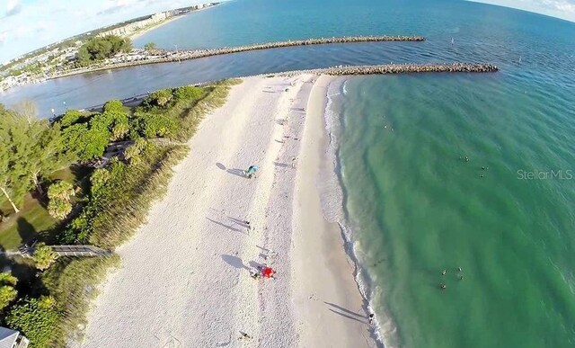 birds eye view of property featuring a water view and a view of the beach