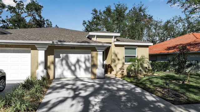 view of front of property featuring a front lawn and a garage