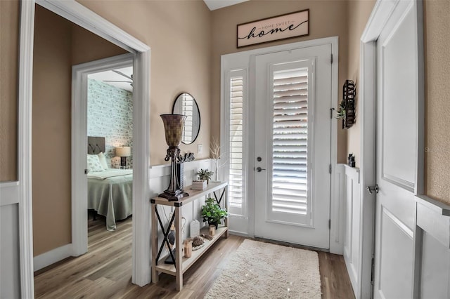 entryway featuring light wood-type flooring and ceiling fan