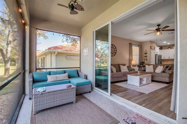 sunroom featuring ceiling fan and a wealth of natural light