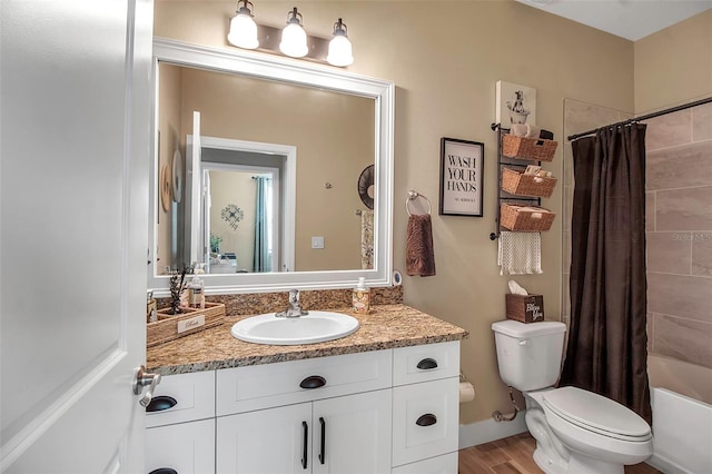 full bathroom featuring hardwood / wood-style floors, vanity, toilet, and shower / bath combo with shower curtain