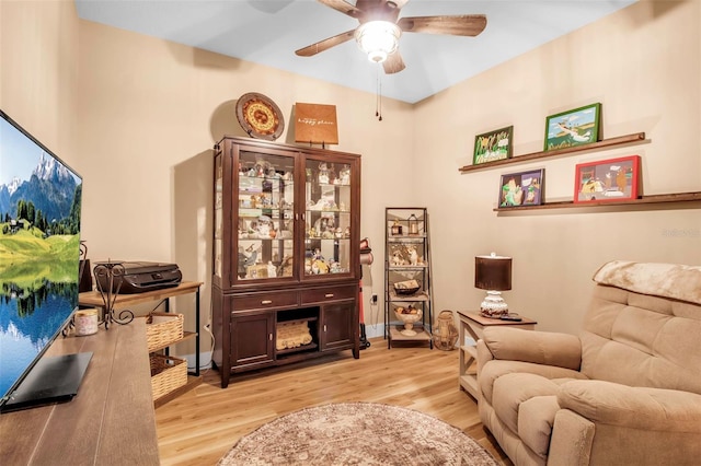 living area with ceiling fan and light hardwood / wood-style floors