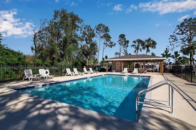 view of swimming pool with a gazebo and a patio area