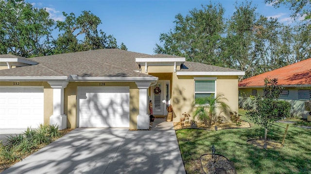 ranch-style house with a garage and a front lawn